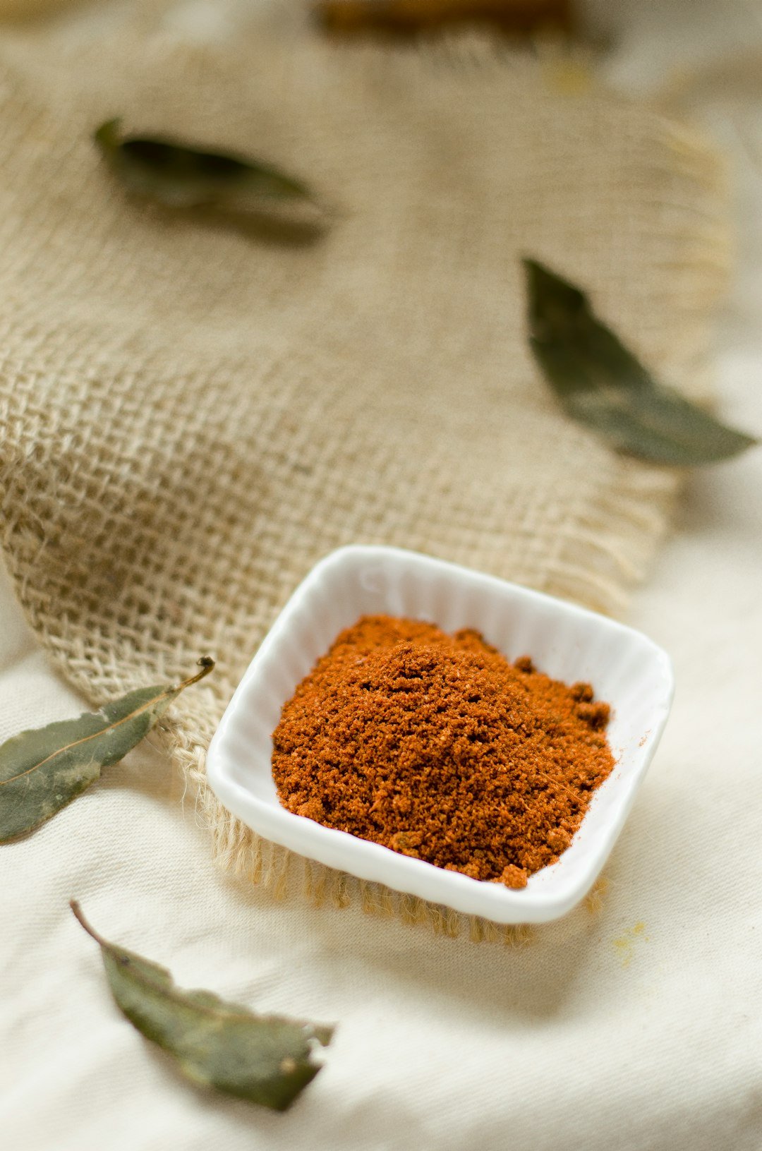 a-small-white-bowl-filled-with-brown-powder-hefp-x-ra1m